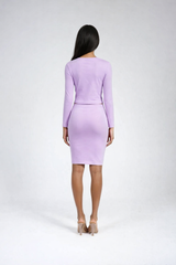 Woman wearing a light purple dress against a white background
