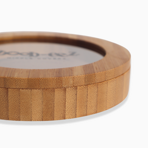 Product shot of the Boob-eez Bamboo Compact, close-up side shot showing the beautiful wood grain detail from the bamboo used to make the compact