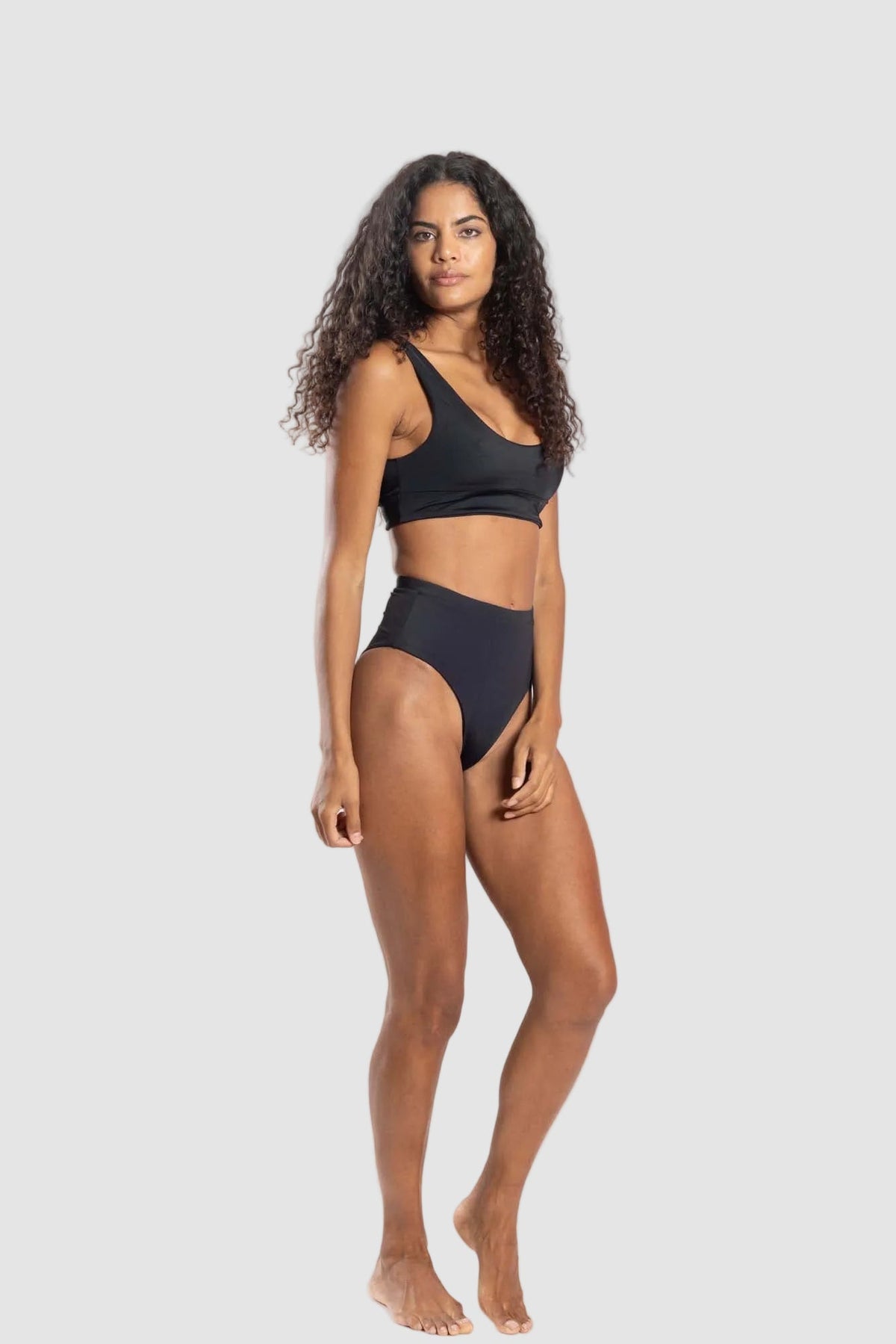 Woman wearing a black bikini on a white background