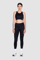 Person wearing a black athletic outfit on a white background