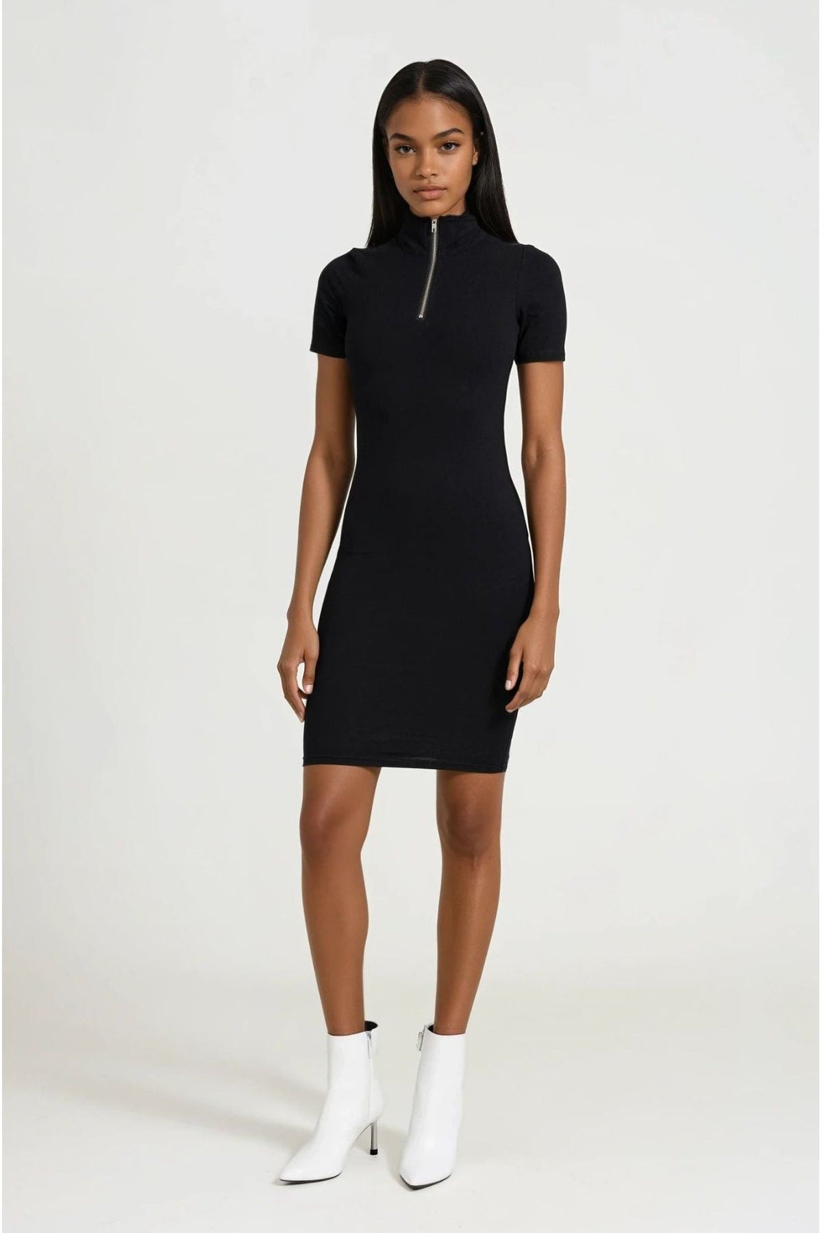 Woman wearing a black dress with a zipper on a white background