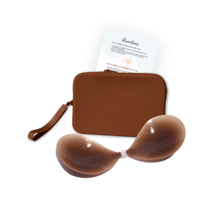 Product shot of sticky Dark tint Silicone Stick-on Bra and durable Silicone Travel Case for Stick-on Bras in Dark Nude and information card with wear and care instructions, against a white background showing the thin edges of the Silicone Stick-on Bra