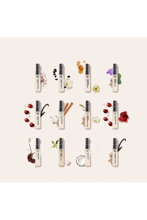Multiple small bottles with floral and fruit decorations on a light background