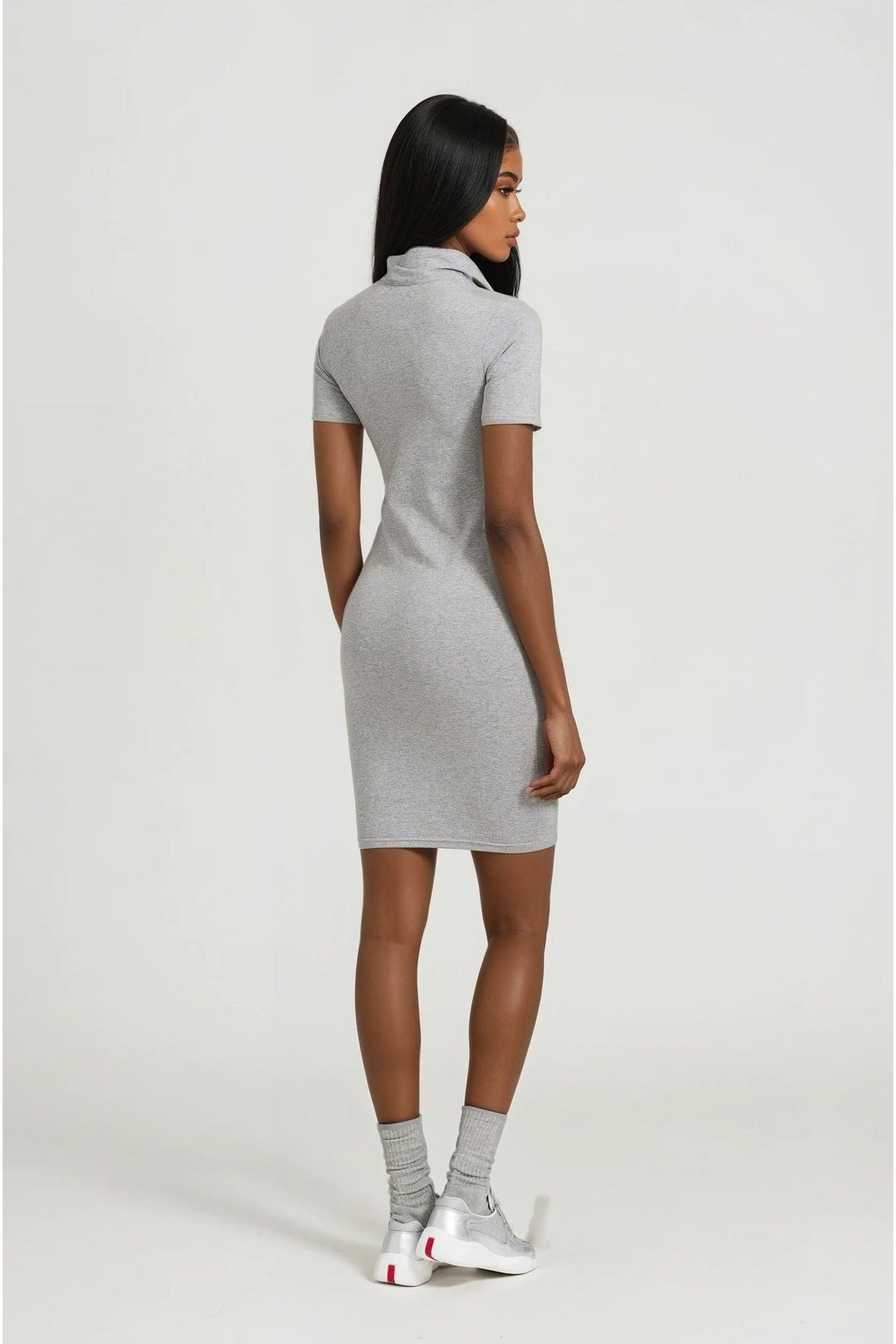 Woman wearing a gray dress on a white background