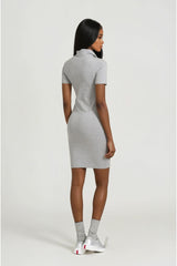 Woman wearing a gray dress on a white background
