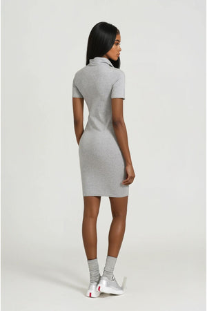 Woman wearing a gray dress on a white background