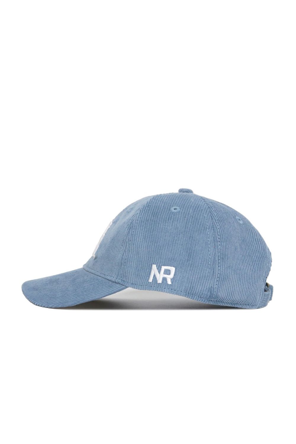 Designed by No Rivals, the Texas A&M Corduroy Hat from the Spring Showers Collection features an unstructured 6-panel style in sky blue corduroy. "NR" is embroidered in white on the side, and the cap is displayed in a left side profile view against a white background. An adjustable strap ensures a comfortable fit.