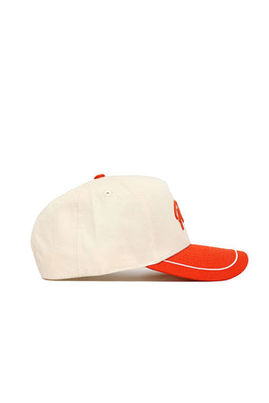 The No Rivals OSU Pokes ALOYO Hat (B2B) is a cream cotton baseball cap with an orange brim, piping, and top button. Seen from the side on a white background, it features a structured fit and a partially visible embroidered front design.