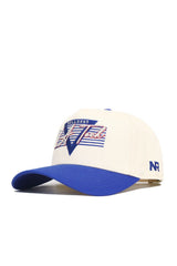 The No Rivals LA Tech Triangle Game Cap Hat is a white cap with a blue brim, featuring "Bulldogs V Tech" embroidered in blue, red, and white on the front and "NR" stitched in blue on the side. Officially licensed with a structured fit.