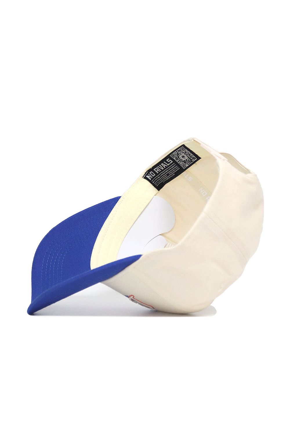 The No Rivals Boise State Triangle Game Cap Hat is displayed flipped over to show its inner tags, lining, and brand label. This structured beige cap has a blue curved brim facing forward and is set against a white background.