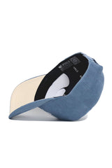 The Iowa Corduroy Hat - Structured - Sky Blue (B2B) by No Rivals is displayed upside down, showing its cream underside brim and a black interior lining with repeated NO RIVALS text.