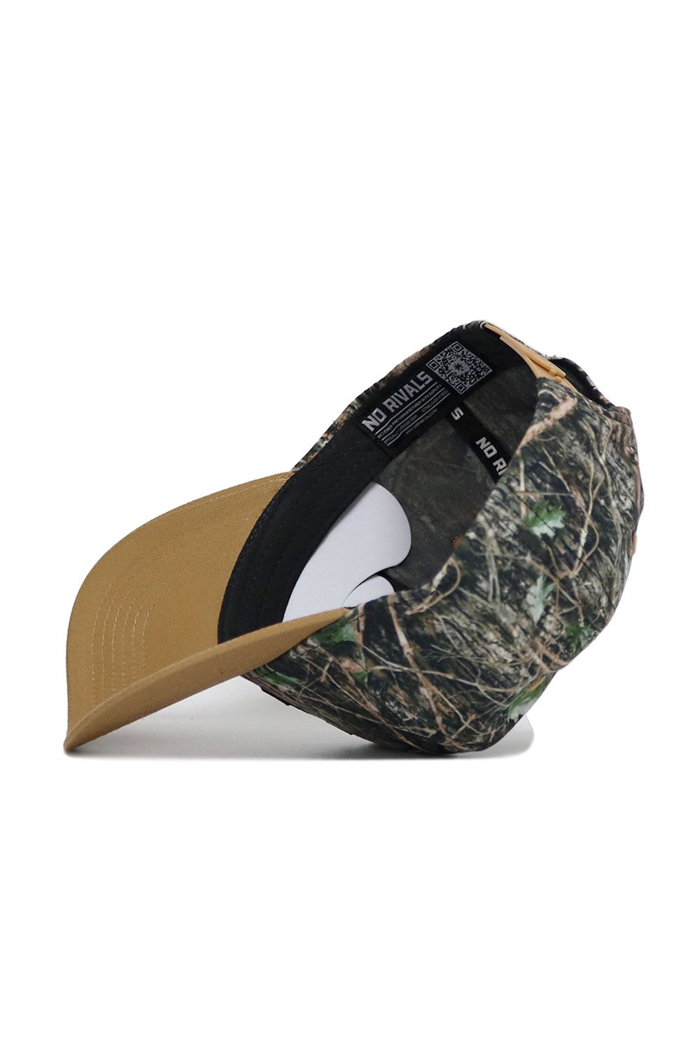 The App State Camo Hat - Explorer Edition features a camouflage pattern, tan brim, and adjustable snapback. Flipped to reveal the inside label, this high-quality cotton hat offers both comfort and durability.