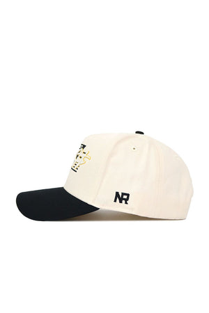 The No Rivals App State Triangle Game Cap Hat features a cream crown, black brim, structured fit, and an embroidered black and gold logo on the front. Black NR initials are stitched on the side. Shown in profile on a white background.