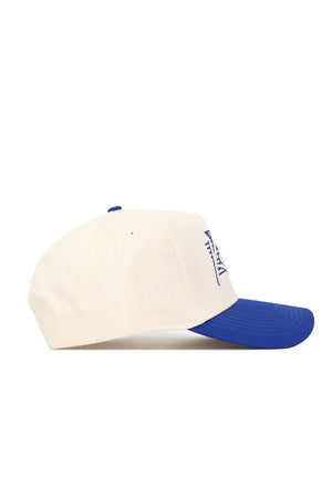 The No Rivals Kentucky Triangle Game Cap Hat is a beige snapback with a blue brim, viewed from the side. It features blue embroidered text or logo on the structured crown and has ventilation holes for comfort.