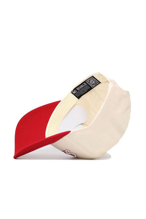 The San Diego State Triangle Game Cap Hat by No Rivals is shown cream-colored, flipped to reveal its red brim, labels—including one with the brand name—structured fit, inner stitching, high-quality cotton, and a visible QR code.