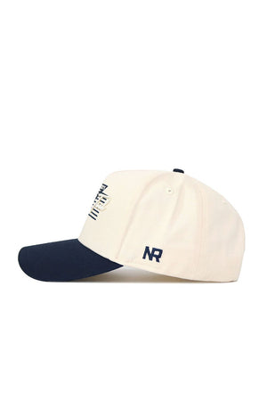 The No Rivals Georgia Tech Triangle Game Cap Hat is cream-colored with a navy brim and button. "NR" is embroidered in navy on the side, with partial navy designs visible on the front. Made from high-quality cotton.