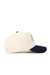 The No Rivals Georgia Tech Triangle Game Cap Hat features a structured fit in beige with a navy blue brim, side view, embroidered front details, and is made from high-quality cotton.