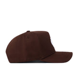 The North Carolina (UNC) Americano Hat (B2B) is a brown snapback with high-quality cotton, curved brim, structured fit, and visible stitching, displayed from the side against a white background.