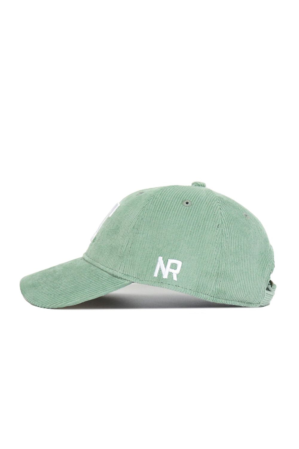 The No Rivals Tennessee Corduroy Hat in Spring Green is shown in side view. This unstructured 6-panel cap features white NR embroidery near the brim, a curved bill, and an adjustable back strap.