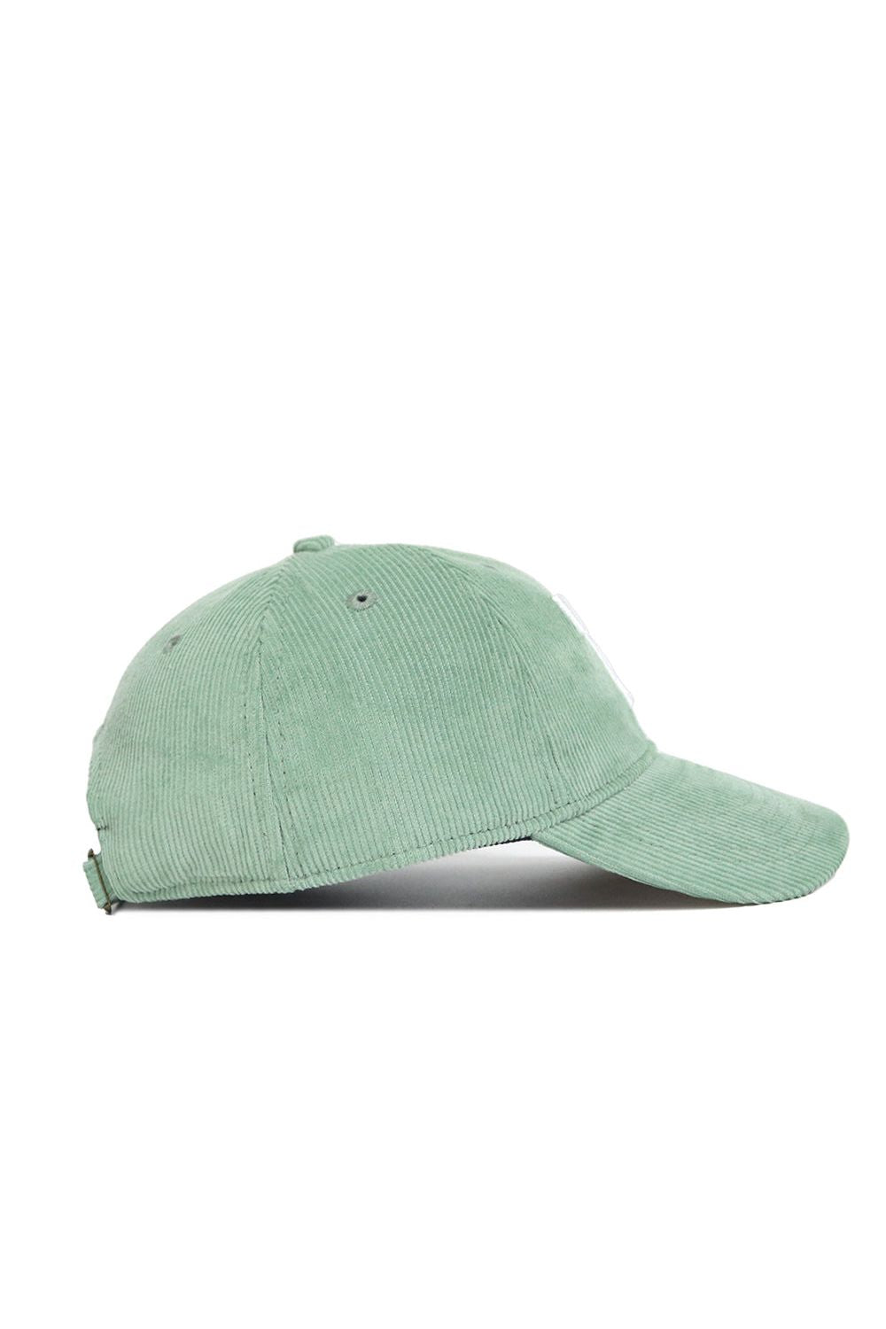 The No Rivals Tennessee Corduroy Hat - Unstructured - Spring Green (B2B) is a light green 6 panel corduroy hat with a curved brim and adjustable back strap for the perfect fit, shown here from the side.