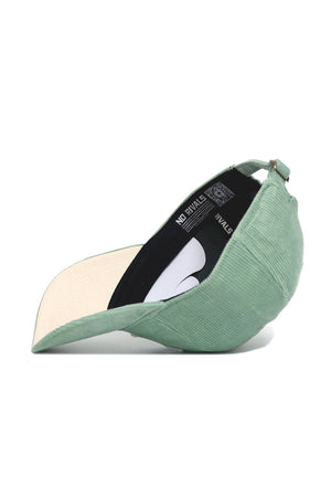 The No Rivals Tennessee Corduroy Hat – Unstructured in Spring Green features a 6-panel design, adjustable strap, and beige underbrim. Shown on its side, the inside label and strap are clearly visible.