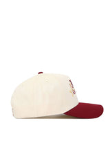 The No Rivals Iowa State Triangle Game Cap Hat features a cream-colored snapback design with a maroon brim, front embroidery, and ventilation eyelets on top. Made from high-quality cotton and shown from the side.