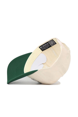 A Hawai'i Triangle Game Cap Hat by No Rivals is flipped upside down, showing the inside label with "NO RIVALS" and a QR code. The structured snapback features a green brim and beige panels, displayed on a white surface.