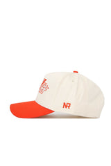 The Oklahoma State Triangle Game Cap Hat by No Rivals features a cream color with a bright orange brim, an orange top button, an orange embroidered front design, and the letters NR in orange on the side.
