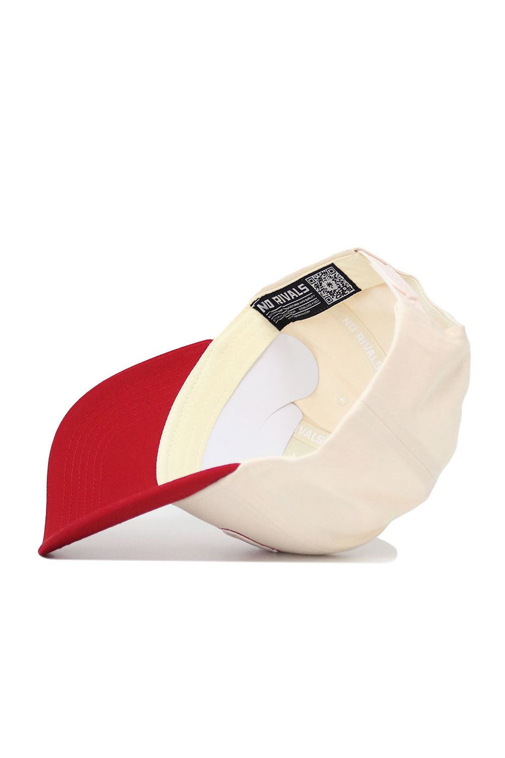 The Oklahoma Triangle Game Cap Hat by No Rivals is a cream-colored, structured fit snapback with a red bill. Seen from inside, it features a NO RIVALS label and a partial QR code on the black inner tag.