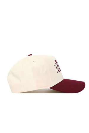 The No Rivals Texas A&M Triangle Game Cap Hat features a cream crown, maroon brim, structured fit, and snapback design, with visible front embroidery shown in side view.