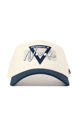The No Rivals Nevada Triangle Game Cap Hat is a cream snapback with a dark brim featuring "University of Nevada" in blue and white, plus a bold Nevada script over a blue triangle. This officially licensed hat offers a structured fit.