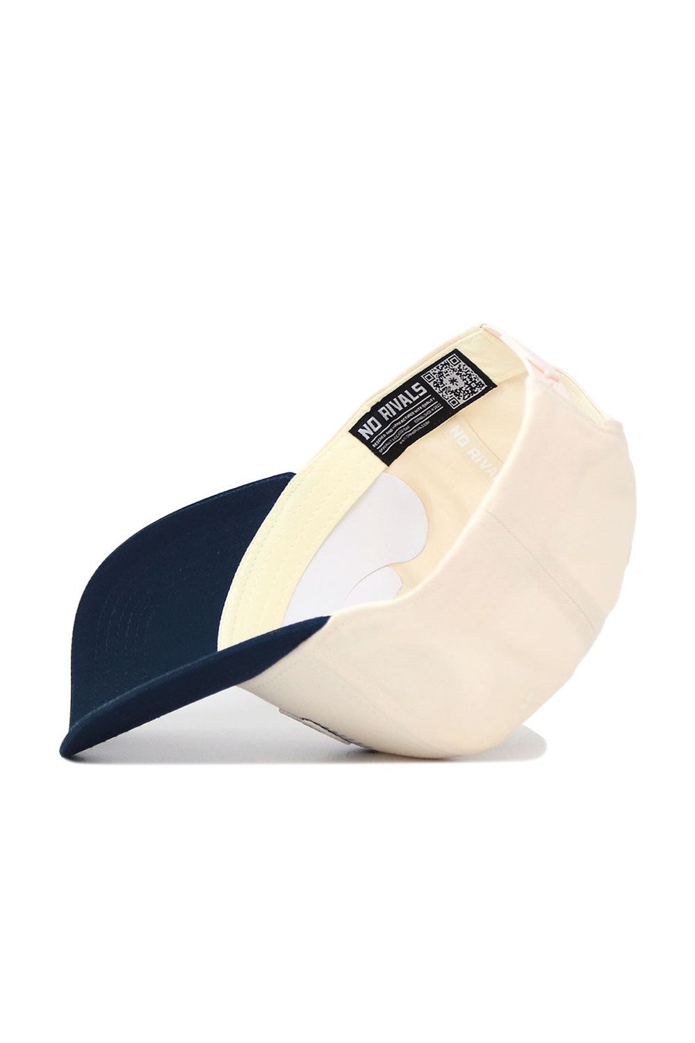 The Nevada Triangle Game Cap Hat by No Rivals is shown flipped upside down, displaying the inside lining, labels, and a black tag with white text and QR code. Its structured fit offers lasting comfort and style.