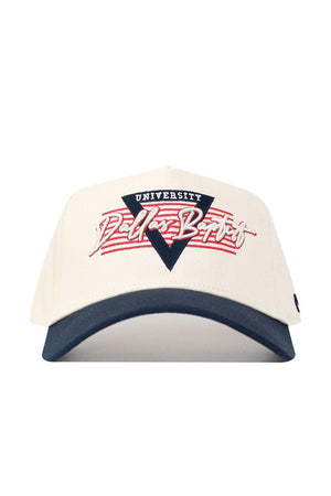 The No Rivals DBU Triangle Game Cap Hat is a white snapback with a navy blue brim, featuring a triangular emblem and "UNIVERSITY Dallas Batist" in red and white on the front. This licensed cap offers a structured, comfortable fit.
