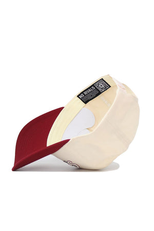 The South Carolina Triangle Game Cap Hat by No Rivals is shown upside down, displaying the inside label and a QR code on the inner band of this structured, high-quality cotton cap. The hat features a beige and maroon color scheme.