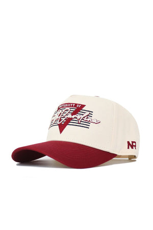 The South Carolina Triangle Game Cap Hat by No Rivals features cream and maroon colors, a maroon bill, "University of South Carolina" with a stylized SC embroidered on front, NR stitched on the side, and high-quality cotton for comfort and structure.