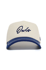 The No Rivals Rice Owls ALOYO Hat is a beige structured cotton cap with a blue brim and "Owls" in blue script on the front, accented by subtle circular text behind the main logo.