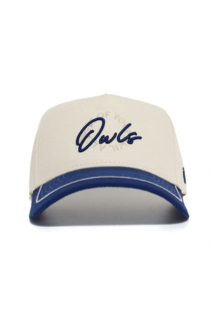 The No Rivals Rice Owls ALOYO Hat is a beige structured cotton cap with a blue brim and "Owls" in blue script on the front, accented by subtle circular text behind the main logo.