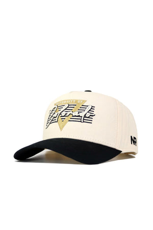The Colorado Triangle Game Cap Hat is a beige baseball cap with a black brim, featuring University of Nevada in gold, black, and white on the front. This officially licensed snapback has NR embroidered in black on the left side.