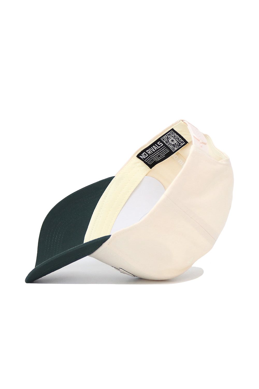 The Michigan State Triangle Game Cap Hat by No Rivals is shown upside down, revealing its inside label with a QR code. This structured beige and dark green cap features a curved bill and an adjustable snap back for comfort.