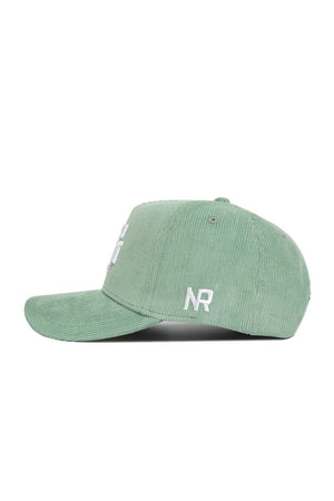 The No Rivals Texas A&M Corduroy Hat in Spring Green is displayed in profile on a white background. This structured snapback features white embroidered NR lettering near the brim.
