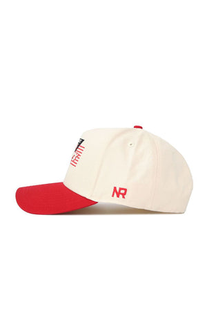 The No Rivals Rutgers Triangle Game Cap Hat features a cream base, red brim, red NR embroidery on the side, a small red top detail, and a partially visible front design. Crafted from high-quality cotton with a structured snapback fit.