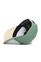 The Texas A&M Corduroy Hat - Structured - Spring Green (B2B) by No Rivals is shown upside down, displaying a cream underside, black inner band with NO RIVALS branding, QR code, and a structured fit for comfort.