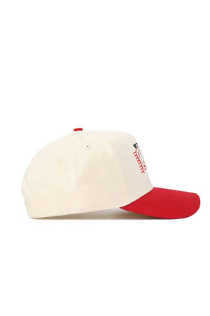 The No Rivals Rutgers Triangle Game Cap Hat features a cream snapback design with a red brim and front red embroidery, made from premium cotton and displayed in side profile against a white background.