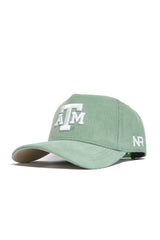 The No Rivals Texas A&M Corduroy Hat in spring green features a white embroidered ATM logo on the front, NR initials on the side, a curved brim, visible stitching, and a structured fit for lasting comfort.