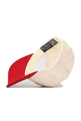 The No Rivals Rutgers Triangle Game Cap Hat is shown from the inside, featuring a cream and red snapback design with the NO RIVALS label and a QR code under the brim. The cap's opening faces forward, highlighting its structured fit.