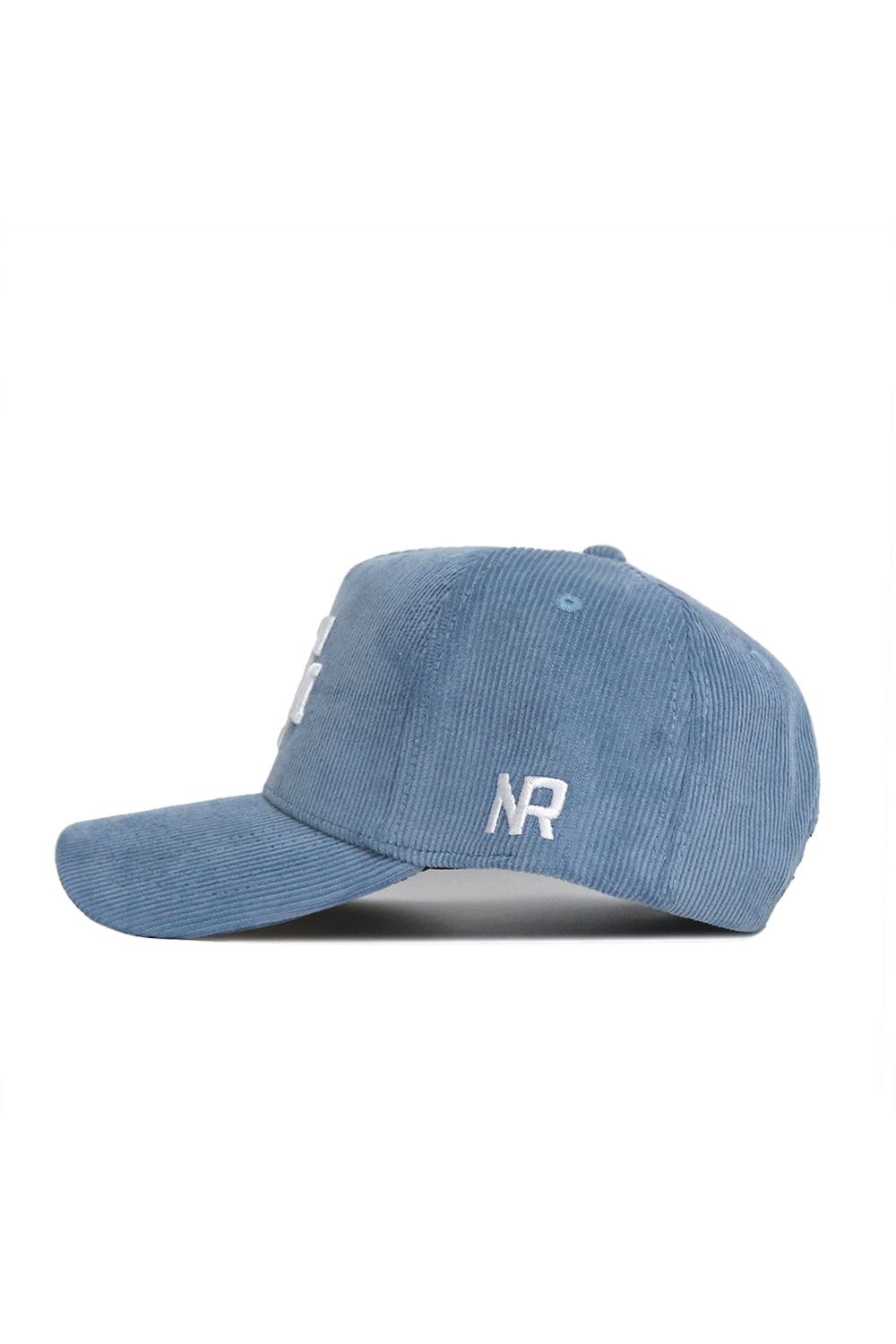 The Texas A&M Corduroy Hat by No Rivals features a sky blue structured snapback design, curved brim, and white "NR" embroidery on the side for a classic look. This officially licensed cap is shown in profile view.