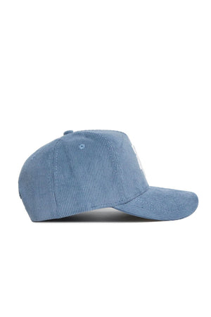 The Texas A&M Corduroy Hat by No Rivals in sky blue is a structured snapback with a curved brim and top button, shown from the side.