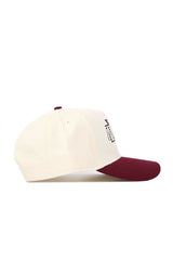The No Rivals New Mexico State Triangle Game Cap Hat is a cream snapback with a maroon brim and top button, shown from the side. It features a structured fit and a maroon embroidered design on the front panel.