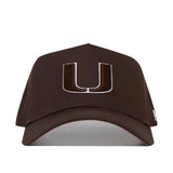 The Miami Hurricanes Americano Hat is a structured brown baseball cap made of high-quality cotton, featuring a large white and brown embroidered "U" logo on the front.
