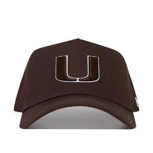 The Miami Hurricanes Americano Hat is a structured brown baseball cap made of high-quality cotton, featuring a large white and brown embroidered "U" logo on the front.